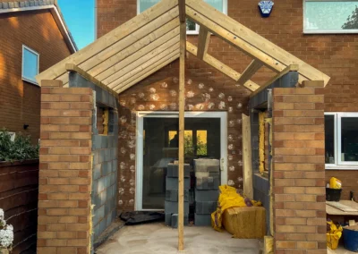 Single storey rear house extension in Stockport showing brickwork, blockwork and new pitched roof structure during the build