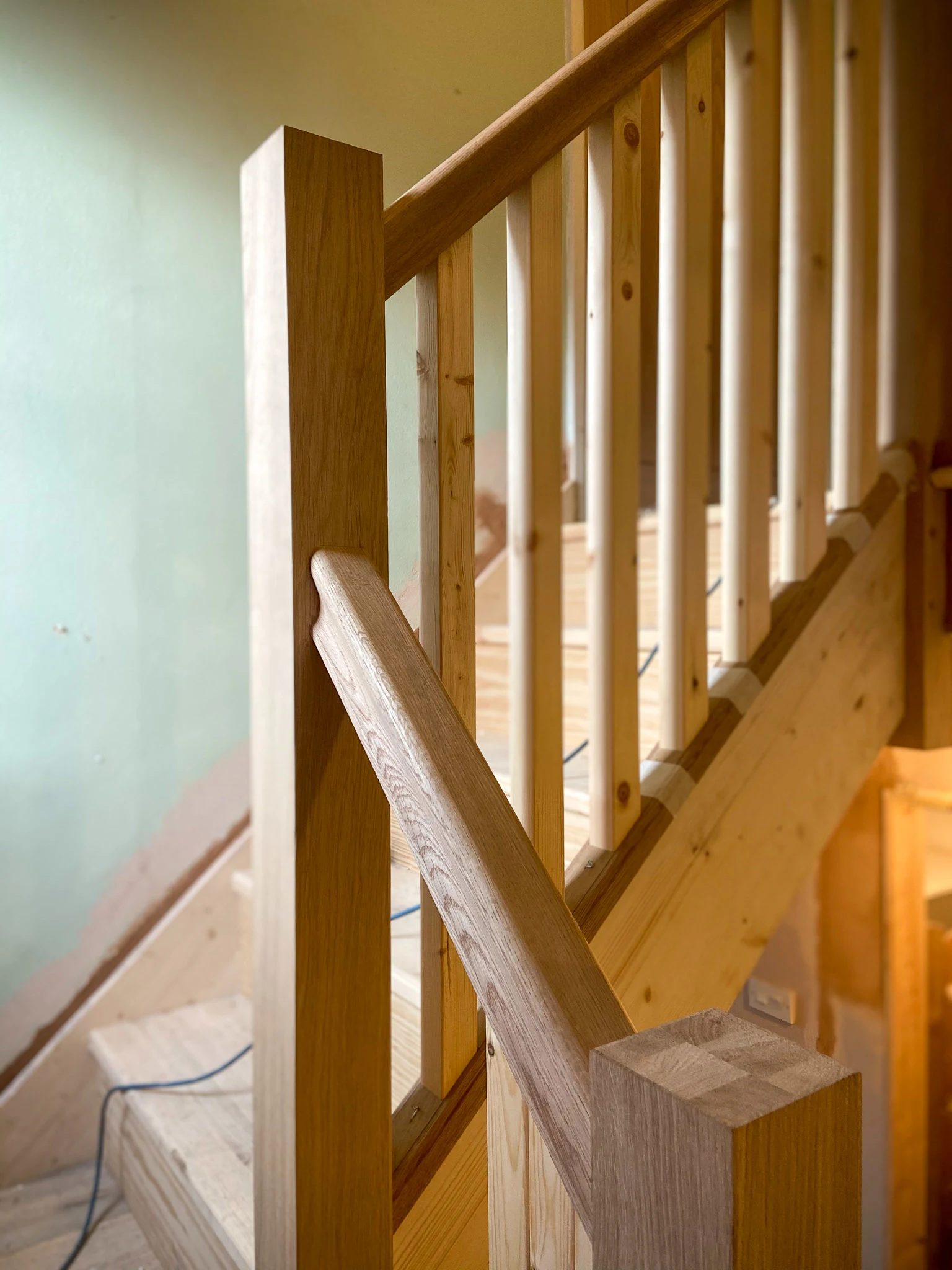 Bespoke oak and timber staircase under construction in a Stockport home by Hive Design & Build