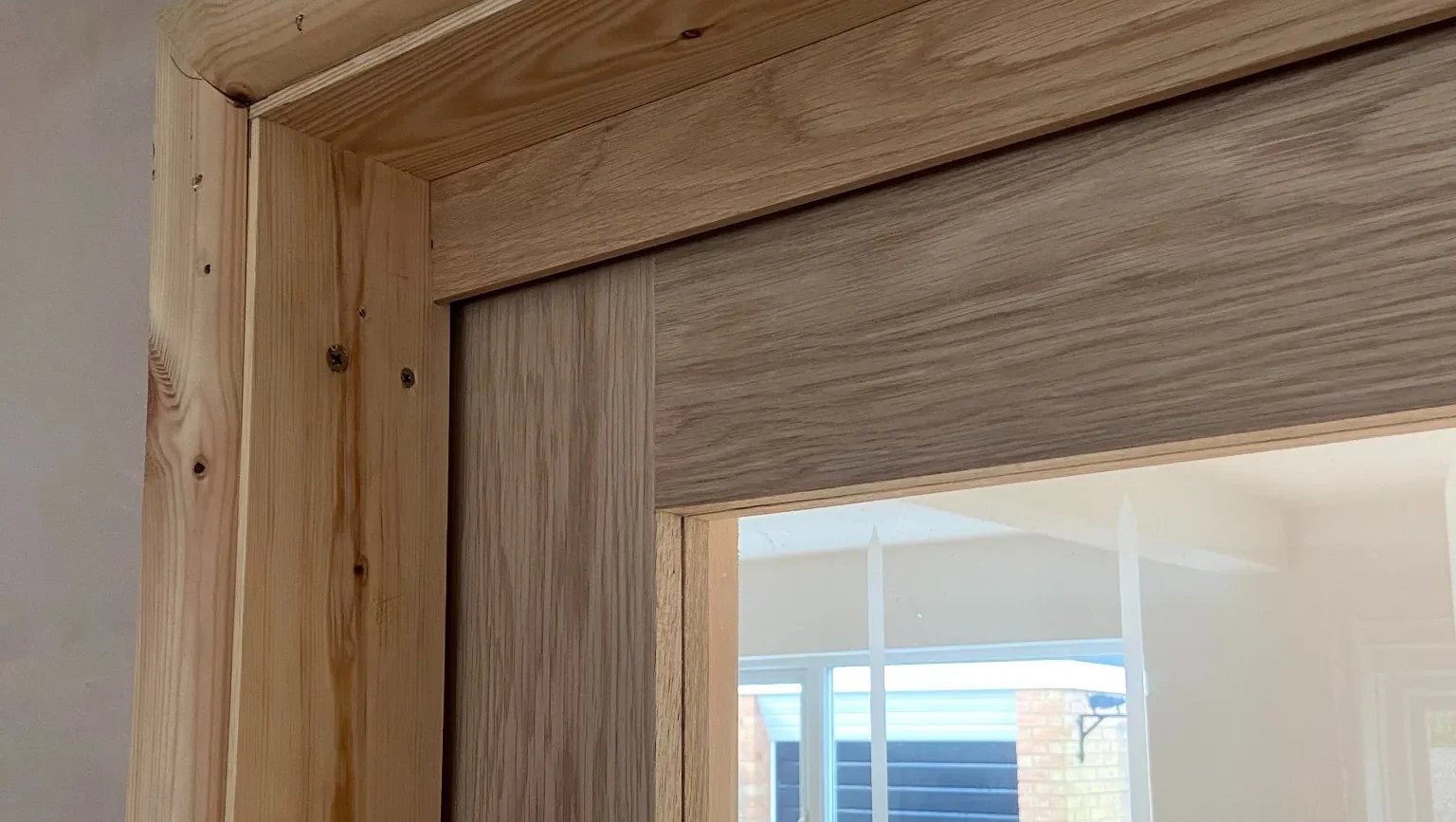 Oak pocket door frame being installed during a kitchen renovation in a Stockport property.